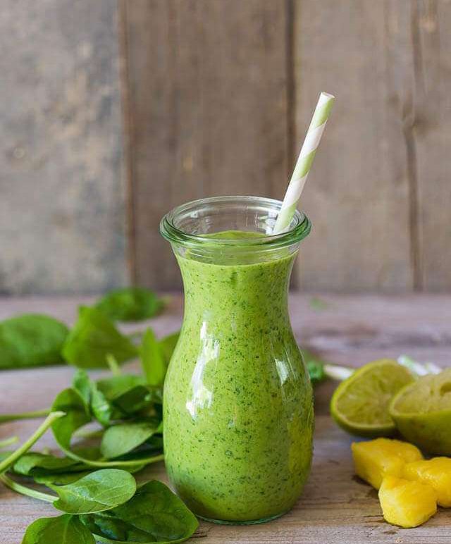 Green smoothie with spinach, mango, pineapple and coconut